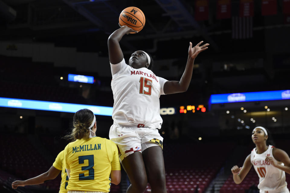 Maryland's Ashley Owusu (15) shoots over UNC Wilmington's Mary McMillan during the first half of an NCAA college basketball game on Thursday, Nov. 18, 2021, in College Park, Md. (AP Photo/Gail Burton)