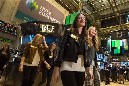 2014 Sports Illustrated Swimsuit Models tour the floor of the New York Stock Exchange February 13, 2014. REUTERS/Brendan McDermid