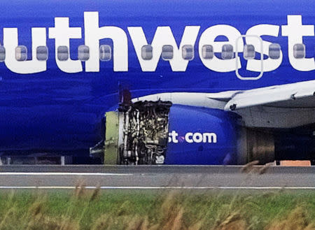 Emergency personnel monitor the damaged engine of Southwest Airlines Flight 1380, which diverted to the Philadelphia International Airport this morning after the airline crew reported damage to one of the aircraft's engines, on a runway in Philadelphia, Pennsylvania U.S. April 17, 2018. REUTERS/Mark Makela