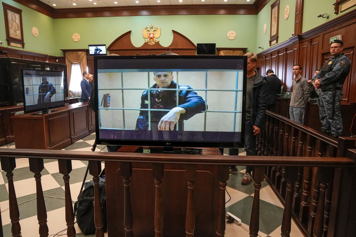 Russian opposition leader Alexei Navalny appears on a screen set up at a court room of the Moscow City Court via a video link from his prison colony provided by the Russian Federal Penitentiary Service during a hearing of an appeal against his nine-year prison sentence in Moscow, Russia, Tuesday, May 24, 2022. A Russian court has rejected Navalny’s appeal of a nine-year prison sentence for fraud. The Tuesday rejection means Navalny will be sent to a strict-regime prison, according to the independent news site Mediazona. (AP Photo/Alexander Zemlianichenko)