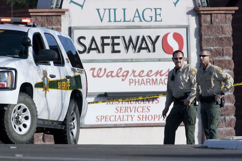 Pima County, Ariz., Sheriff's deputies stand guard at the entranceway to the assassination site one day after a gunman shot and killed six people incuding U.S District Judge John Roll and critically injured U.S Rep. Gabrielle Giffords in Tucson on January 8, 2011. File Photo by Gary C. Caskey