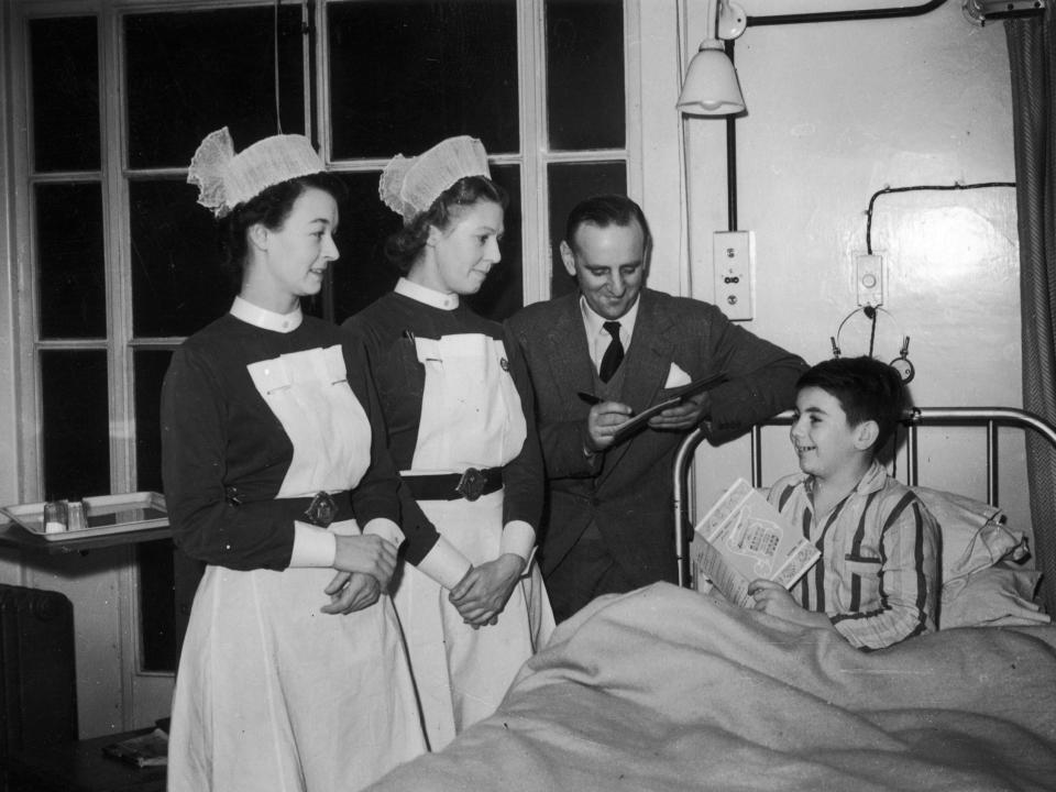 Nurses checking in on a patient on December 9, 1952.