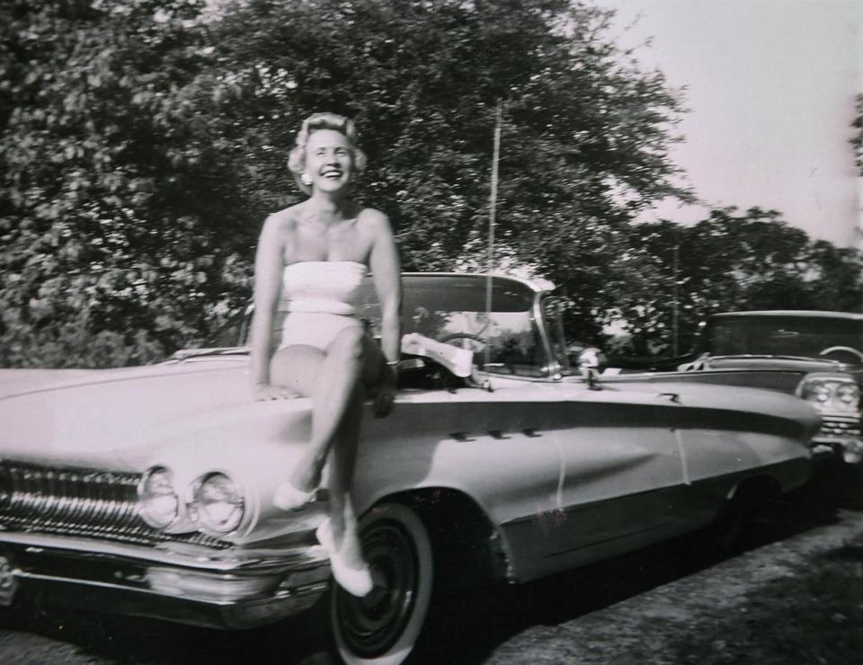 Wally Neef's wife, Zelma, is pictured sitting on the hood of a convertible.