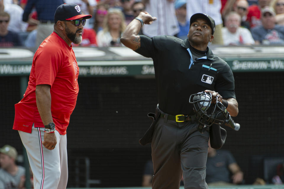 Umpire Malachi Moore, right, ejects Washington Nationals manager Dave Martinez, left, after a third strike argument during the third inning of a baseball game against the Cleveland Guardians in Cleveland, Saturday, June 1, 2024. (AP Photo/Phil Long)