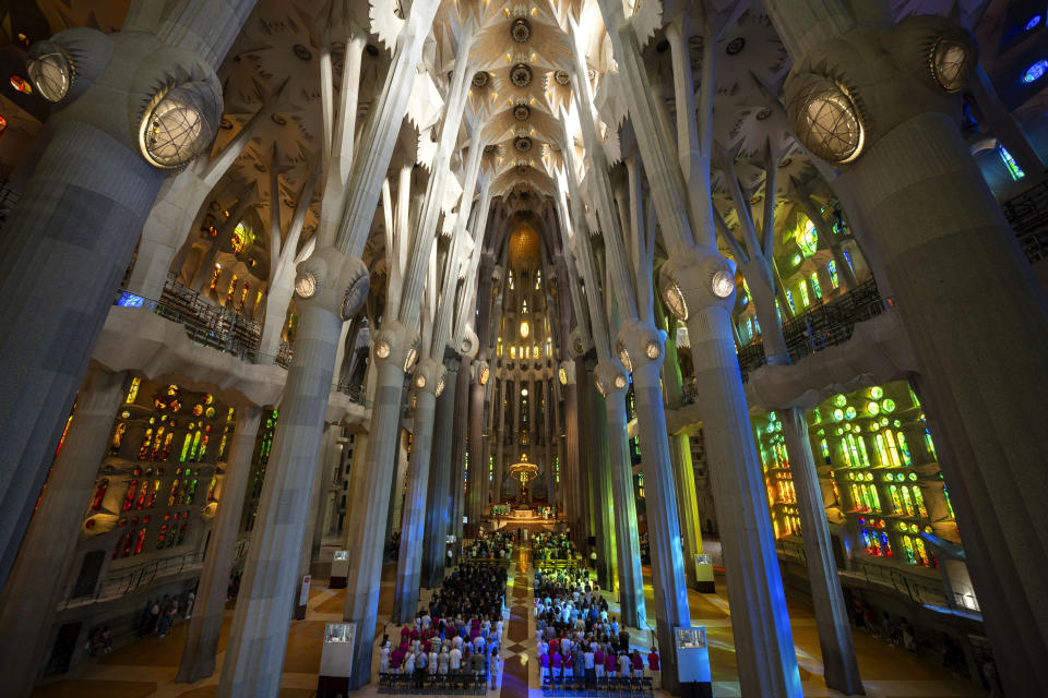 Worshippers attend a Mass in the Sagrada Familia basilica in Barcelona, Spain, Sunday, July 9, 2023. With tourism reaching or surpassing pre-pandemic levels across Southern Europe this summer, iconic sacred sites struggle to find ways to accommodate both the faithful who come to pray and millions of increasingly secular visitors attracted by art and architecture. (AP Photo/Emilio Morenatti)