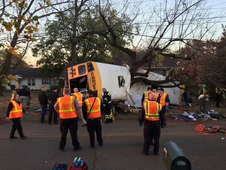 Rescue officials at the scene of a school bus crash involving several fatalities in Chattanooga, Tennessee, U.S., November 21, 2016. Courtesy of Chattanooga Fire Dept/Handout via REUTERS