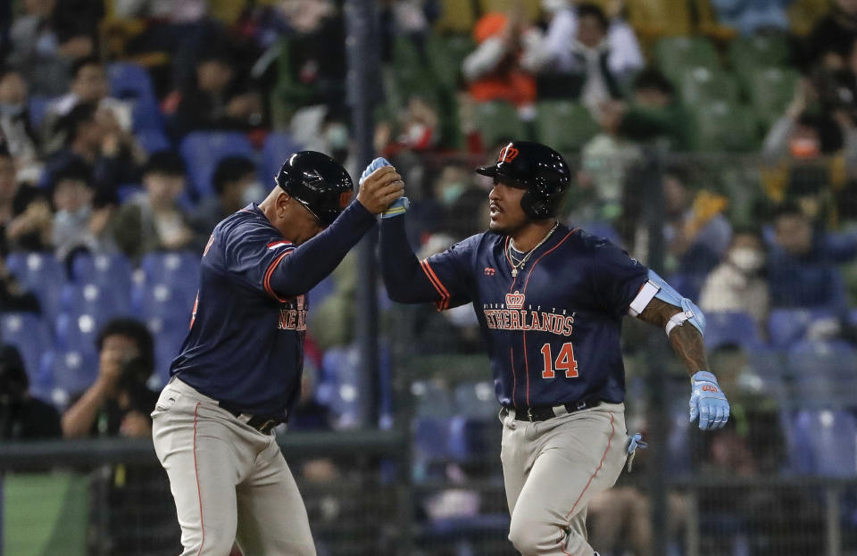 Chadwick Tromp of the Netherlands, right, celebrates with a teammate after hitting a solo home run during the third inning of a Pool A game against Italy at the World Baseball Classic (WBC) at Taichung Intercontinental Baseball Stadium in Taichung, Taiwan, Sunday, March 12, 2023. (AP Photo/I-Hwa Cheng)