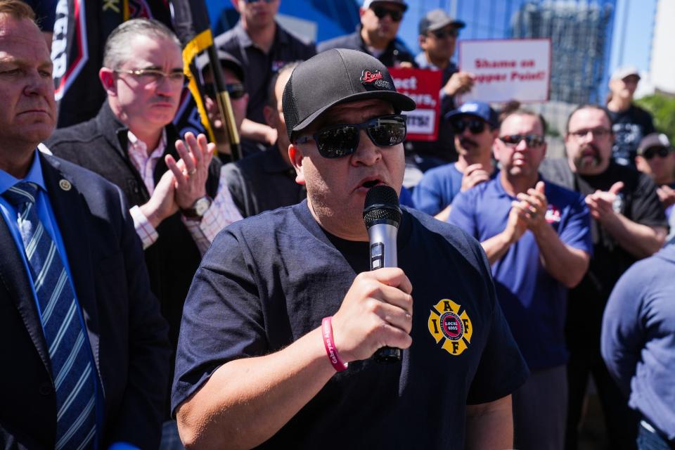 Goodyear firefighter Gilbert Aguirre speaks about his cancer diagnosis and claim denial outside the CopperPoint Insurance Companies building on April 5, 2023, in Phoenix. Aguirre was diagnosed with chronic myeloid leukemia, a work-related cancer, in 2015. The insurance company has repeatedly declined Aguirre's workers' compensation claim, arguing he failed to prove he got cancer on the job.