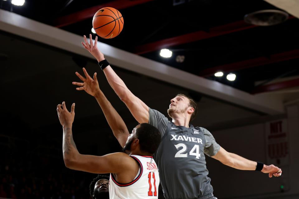 Xavier forward Jack Nunge (24) grabs a rebound over St. John's center Joel Soriano during the teams' first game this season in New York. With XU big man Zach Freemantle out with an injury, Nunge will be asked to defend Soriano, who averages a double-double, Saturday.