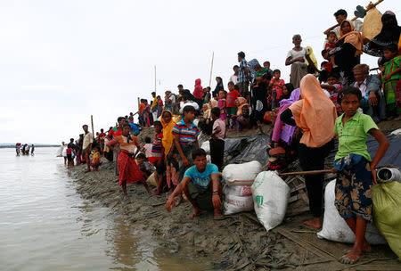 Rohingya refugees wait at a jetty after crossing the Bangladesh-Myanmar border by boat through the Bay of Bengal in Shah Porir Dwip, Bangladesh, September 10, 2017. REUTERS/Danish Siddiqui