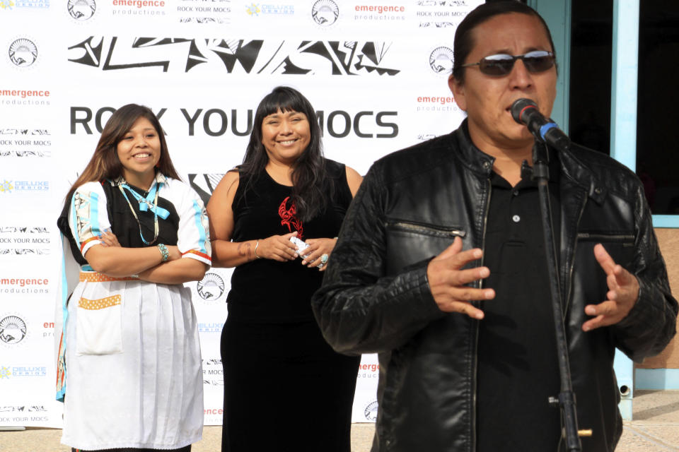 Jessica "Jaylyn" Atsye of Laguna Pueblo, left, and Melissa Sanchez listen as Emmett Shkeme Garcia talks about the importance of the "Rock Your Mocs" campaign during a celebration at the Indian Pueblo Cultural Center in Albuquerque, N.M., on Friday, Nov. 15, 2013. The social media campaign started by Atsye has gone global with Native American and indigenous people from as far away as New Zealand participating. (AP Photo/Susan Montoya Bryan)