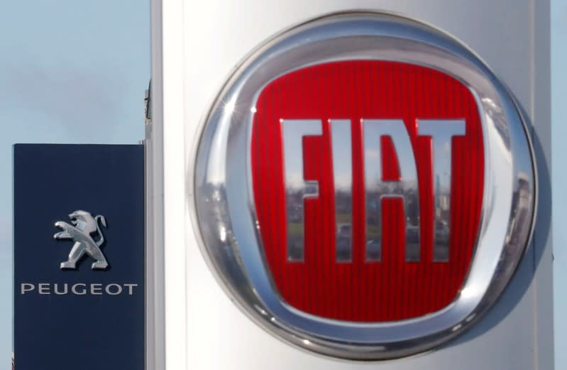 FILE PHOTO: The logos of car manufacturers Fiat and Peugeot are seen in front of dealerships of the companies in Saint-Nazaire