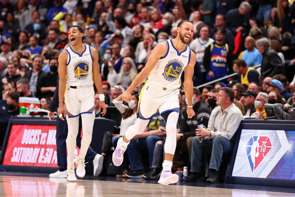 DENVER, CO - MARCH 10: Stephen Curry #30 and Jordan Poole #3 of the Golden State Warriors celebrate their victory against the Denver Nuggets at Ball Arena on March 10, 2022 in Denver, Colorado.  NOTE TO USER: User expressly acknowledges and agrees that, by downloading and or using this photograph, User is consenting to the terms and conditions of the Getty Images License Agreement. (Photo by Jamie Schwaberow/Getty Images)