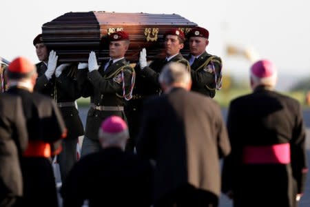 Soldiers carry a coffin with the remains of Czech cardinal Josef Beran after its arrival to the Kbely airport in Prague, Czech Republic, April 20, 2018.  REUTERS/David W Cerny