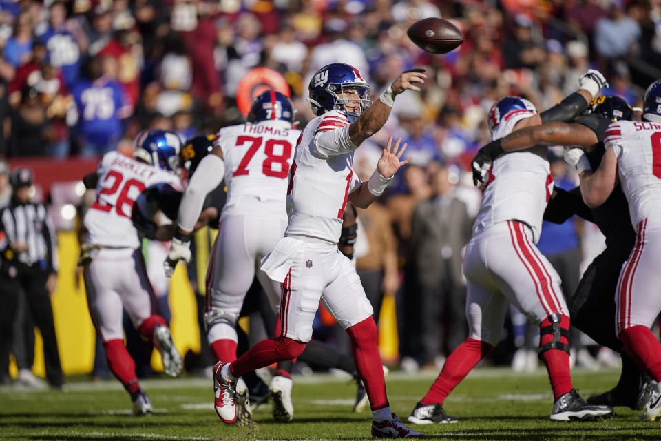 New York Giants quarterback Tommy DeVito (15) throws the ball during the first half of an NFL football game against the Washington Commanders, Sunday, Nov. 19, 2023, in Landover, Md. (AP Photo/Stephanie Scarbrough)