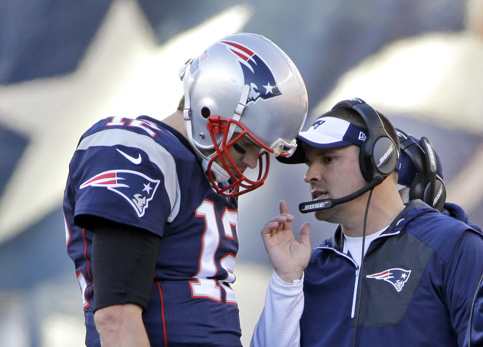 Tom Brady confers with offensive coordinator Josh McDaniels, who became the Colts' new head coach on Tuesday. (AP)