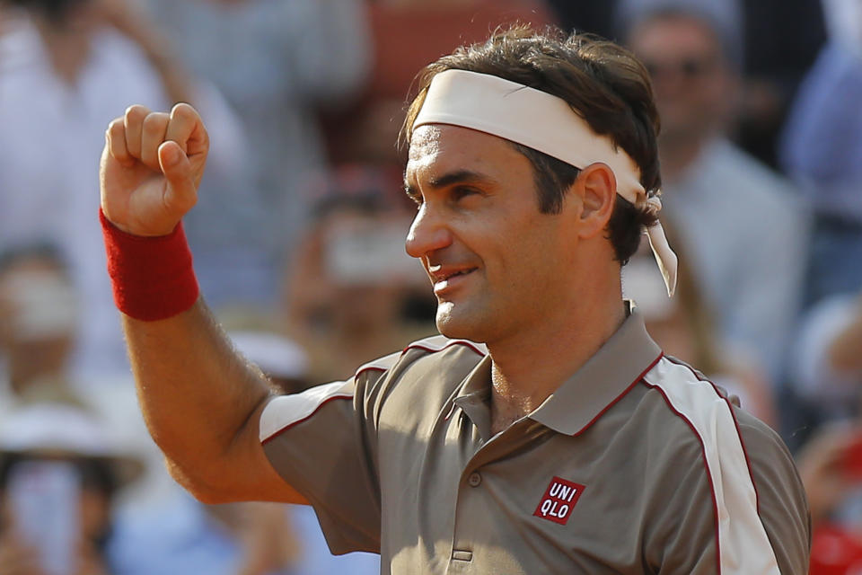 Switzerland's Roger Federer celebrates winning his quarterfinal match of the French Open tennis tournament against Switzerland's Stan Wawrinka in four sets, 7-6 (7-4), 4-6, 7-6 (7-5), 6-4, at the Roland Garros stadium in Paris, Tuesday, June 4, 2019. (AP Photo/Michel Euler)