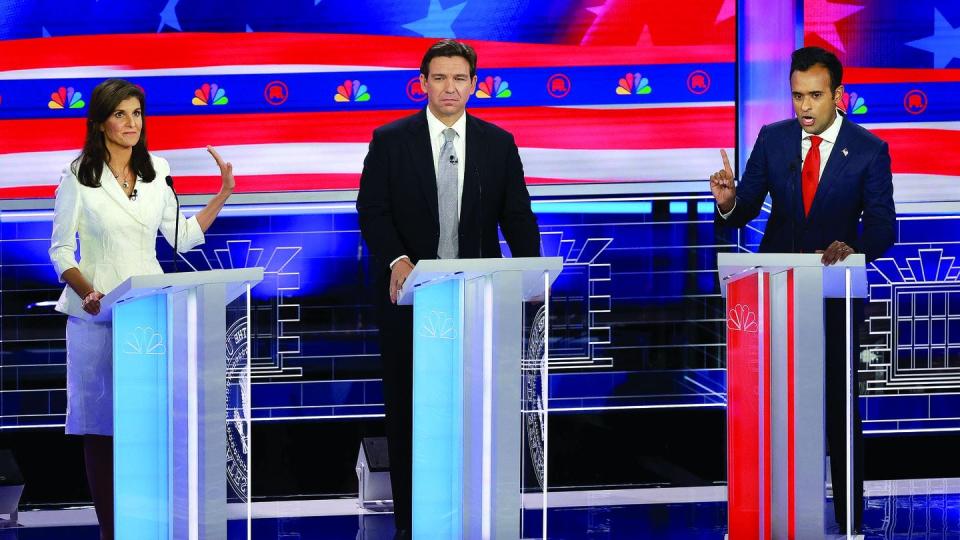 Republican presidential candidate Nikki Haley puts her hand up to Vivek Ramaswamy while he speaks to her as Florida Gov. Ron DeSantis, center, listens during a Republican presidential primary debate Nov. 8, 2023, in Miami, Fla. (Joe Raedle/Getty Images)