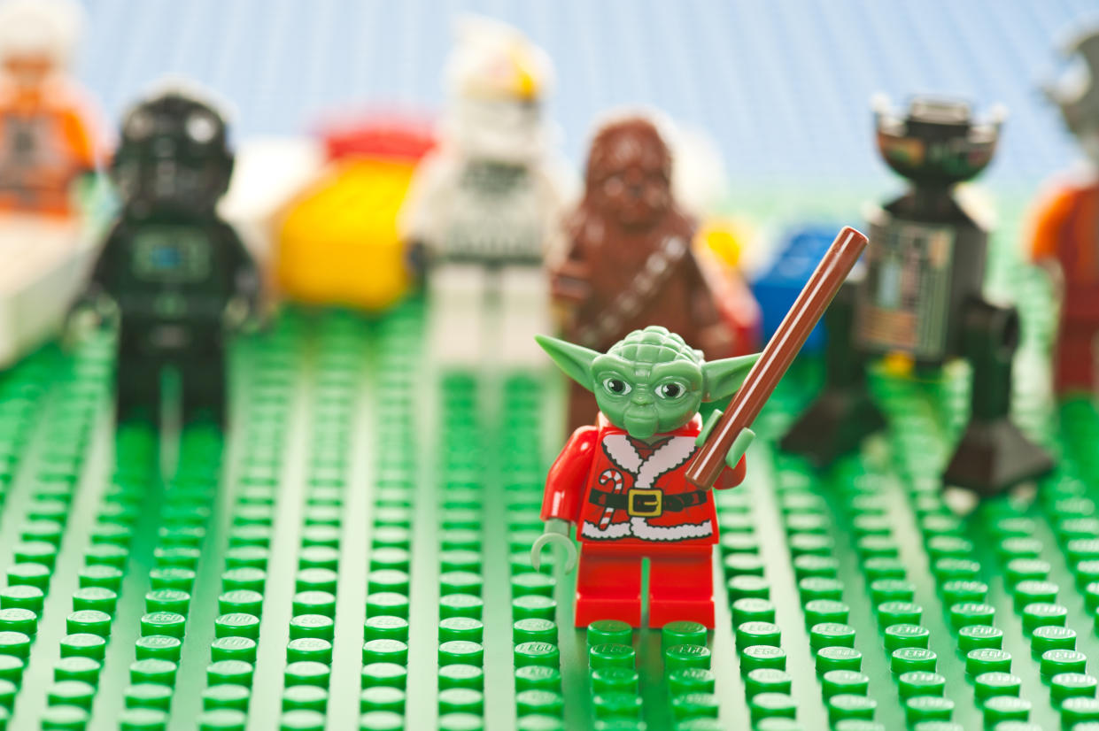 Albuquerque, USA - January 2, 2012: Lego Star Wars figures on green base plate. The Lego toys were originally designed in the 1940s in Denmark and have achieved an international appeal.