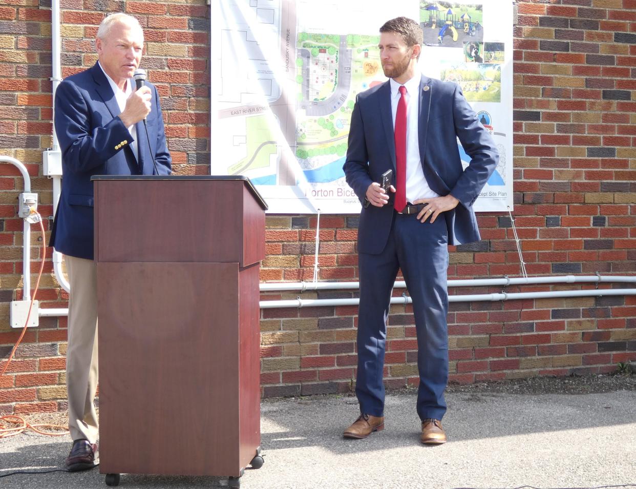 State Sen. Bill Reineke, left, and state Rep. Riordan McClain attended a ceremony on Monday morning in front of the old ice plant at 520 N. Sandusky Ave. to announce state grants that will help fund demolition of the building.