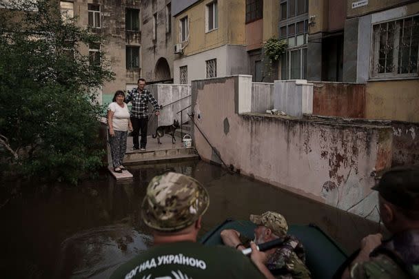 PHOTO: Military chaplains talk to residents stranded in a flooded neighborhood in Kherson, Ukraine, June 7, 2023. (Felipe Dana/AP)