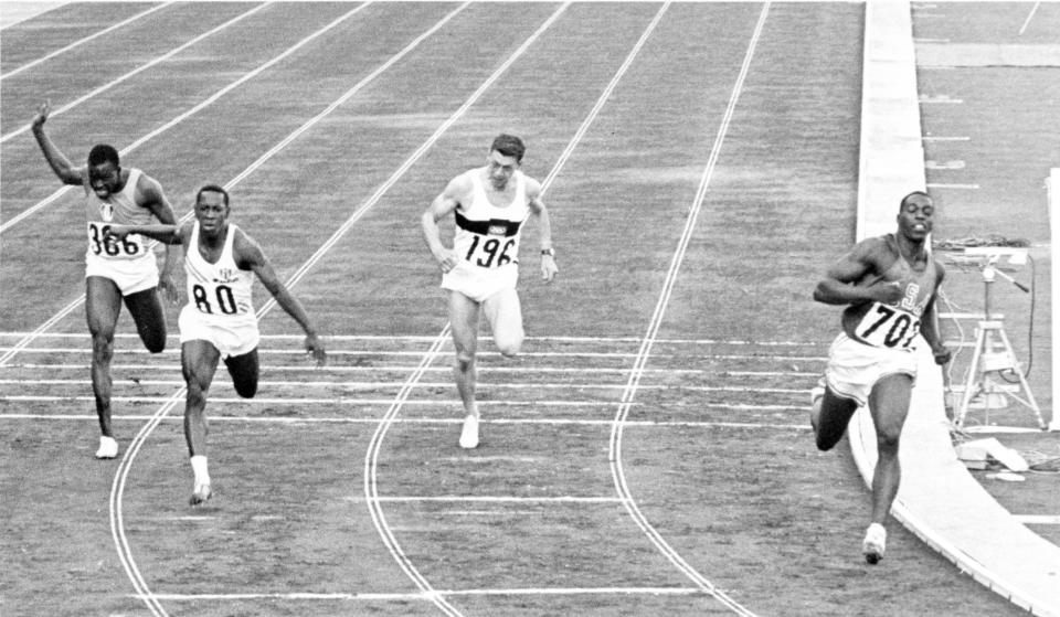 FILE - In this Oct. 15, 1964, file photo, Bob Hayes of United States, right, wins the men's 100-meter final during the Summer Olympic Games at the National Stadium in Tokyo. (AP Photo/File)