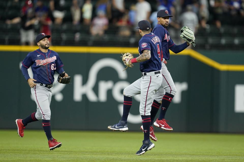 Minnesota Twins' Gilberto Celestino, left, Carlos Correa and Byron Buxton, right, celebrate their 6-5 win in a baseball game against the Texas Rangers, Sunday, July 10, 2022, in Arlington, Texas. (AP Photo/Tony Gutierrez)