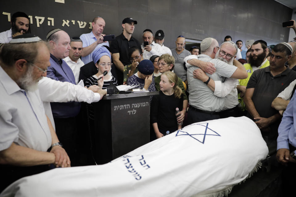 People attend the funeral of 17 year old Rina Shnerb, in Lod, Israel, Friday, Aug. 23, 2019. Shnerb has died of wounds from an explosion in the West Bank that the Israeli military has described as a Palestinian attack. (AP Photo/Sebastian Scheiner)