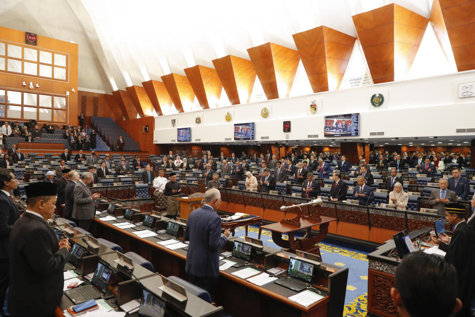 Malaysian politician Anwar Ibrahim, center left, prays along with other parliament members after he was sworn in as a lawmaker at the parliament in Kuala Lumpur, Monday, Oct. 15, 2018. Charismatic Malaysian politician Anwar won a by-election for a parliamentary seat with a landslide victory on Saturday in a grand political comeback to help him prepare for his eventual takeover from Prime Minister Mahathir Mohamad.(AP Photo/Vincent Thian)