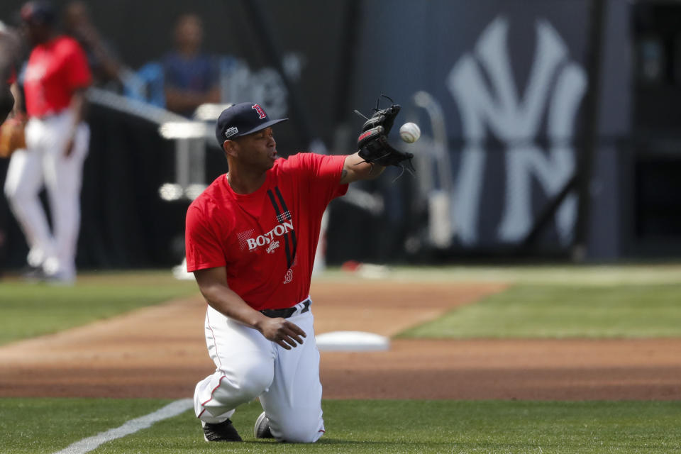 FILE - Boston Red Sox third baseman Rafael Devers catches a ball during batting practice in London, on June 28, 2019. The baseball field being installed at London Stadium will be slightly bigger than the one in 2019. The St. Louis Cardinals and Chicago Cubs will play two games at the home of Premier League club West Ham next weekend. (AP Photo/Frank Augstein, File)