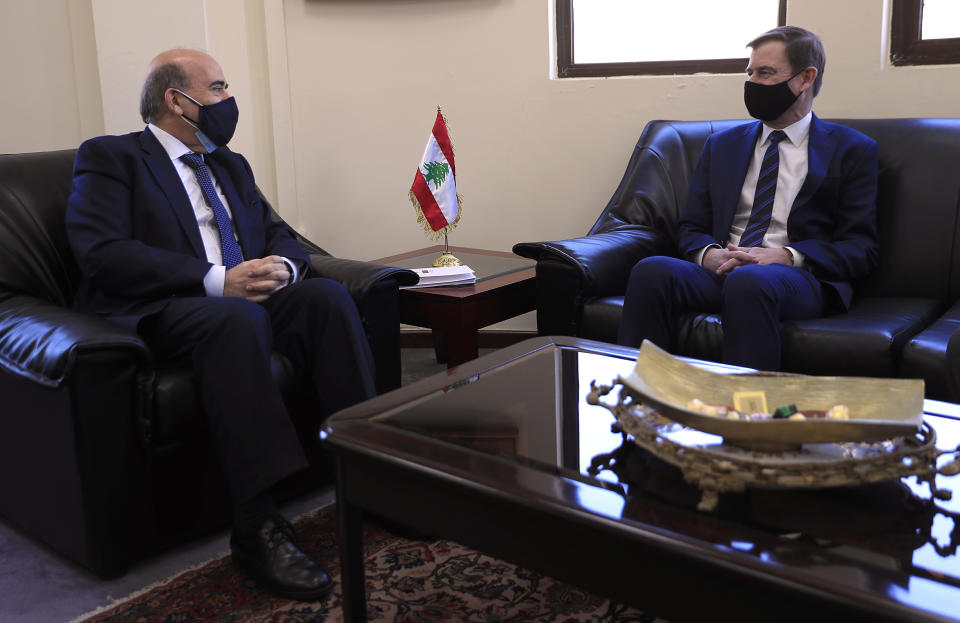 U.S. Undersecretary of State for Political Affairs David Hale, right, meets with the Lebanese Foreign Minister Charbel Wehbe, in Beirut, Lebanon, Wednesday, April 14, 2021. Hale berated Lebanese officials for fighting over the shape of a new government for months while millions of Lebanese endure mounting economic and social hardship. (AP Photo/Hussein Malla)