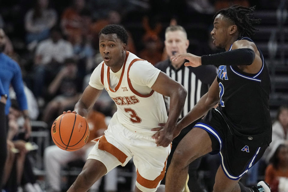 Texas guard Max Abmas (3) drives against Texas-Arlington guard Makaih Williams (2) during the second half of an NCAA college basketball game in Austin, Texas, Monday, Jan. 1, 2024. (AP Photo/Eric Gay)