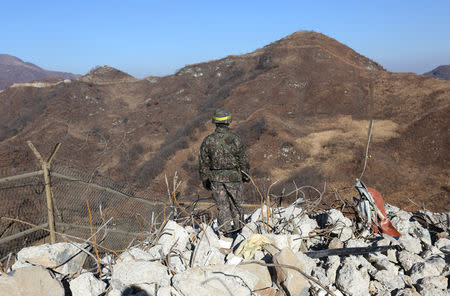 A South Korean army soldier stands guard at the South's dismantled guard post inside the Demilitarized Zone (DMZ) in the central section of the inter-Korean border in Cheorwon, December 12, 2018. Ahn Young-joon/Pool via REUTERS