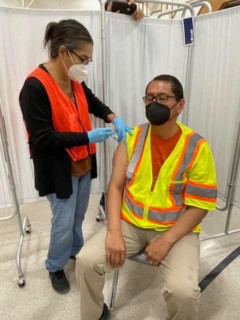 Navajo Nation President Jonathan Nez receives a  COVID-19 booster shot on Nov. 20 in Piñon, Arizona. Nez and first lady Phefelia Nez received booster doses while their son, Alexander Nez, 6, received his first dose.
