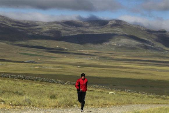 Marathon runner Gladys Tejeda, the first Peruvian athlete who qualified for the 2012 London Olympic Games, runs during her training in the Andean province of Junin May 15, 2012. A private company will take Gladys' mother Marcelina Pucuhuaranga, 69, to London as part of the "Thank you Mom" program. For Pucuhuaranga, who received her first passport, it will be the first time traveling out of Peru. The program will take about 120 mothers of different athletes around the world to attend the games. Tejeda, the youngest of nine children, returned to her hometown to visit her mother and to focus on training where she will run more than 20 km every day in the highlands (over 4,105 meters above sea level).