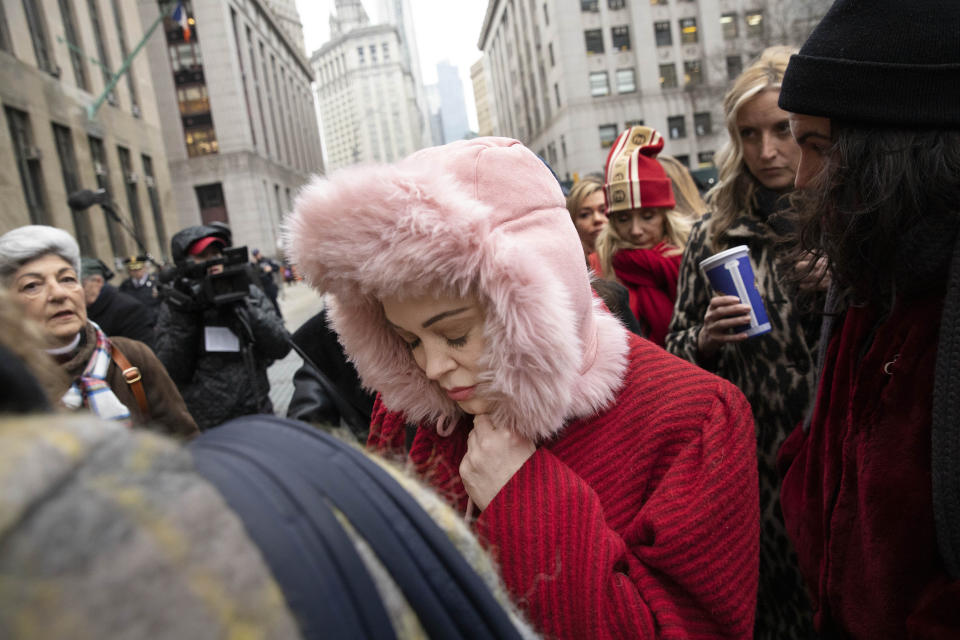 Actor Rose McGowan makes her way through the crowd at a Manhattan courthouse after the arrival of Harvey Weinstein, Monday, Jan. 6, 2020, in New York. Weinstein and several women who have accused him of sexual misconduct converged at the New York City courthouse ahead of his trial on charges of rape and sexual assault. (AP Photo/Mark Lennihan)