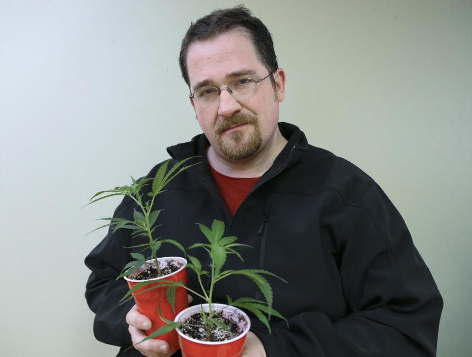 Paul Schrag holds two cloned plants that will be used to grow medical marijuana Wednesday, Nov. 13, 2013, in Tacoma, Wash. Schrag has a simple philosophy: He hopes to use his skills to do the most good in the world. For a while, that meant working in journalism, enticed by its power to shape public discourse. Before being laid off in 2009, he worked as a reporter for the Business Examiner, a biweekly publication in Tacoma. Nowadays, it means working in the pot industry. The 40-year-old says he’s been growing marijuana since 1999 and uses it to treat lifelong neck pain. He began working at a medical marijuana collective, where part of his job entails coming up with a marketing and public education plan to help erase any stigma associated with cannabis use. He believes the medical and social benefits of the plant are only just starting to be understood. He plans to work as a grower’s vice president of marketing, research and development, and believes his knowledge of pot and business will help. “I’m one of those rare cats that get both,” he says. (AP Photo/Ted S. Warren)