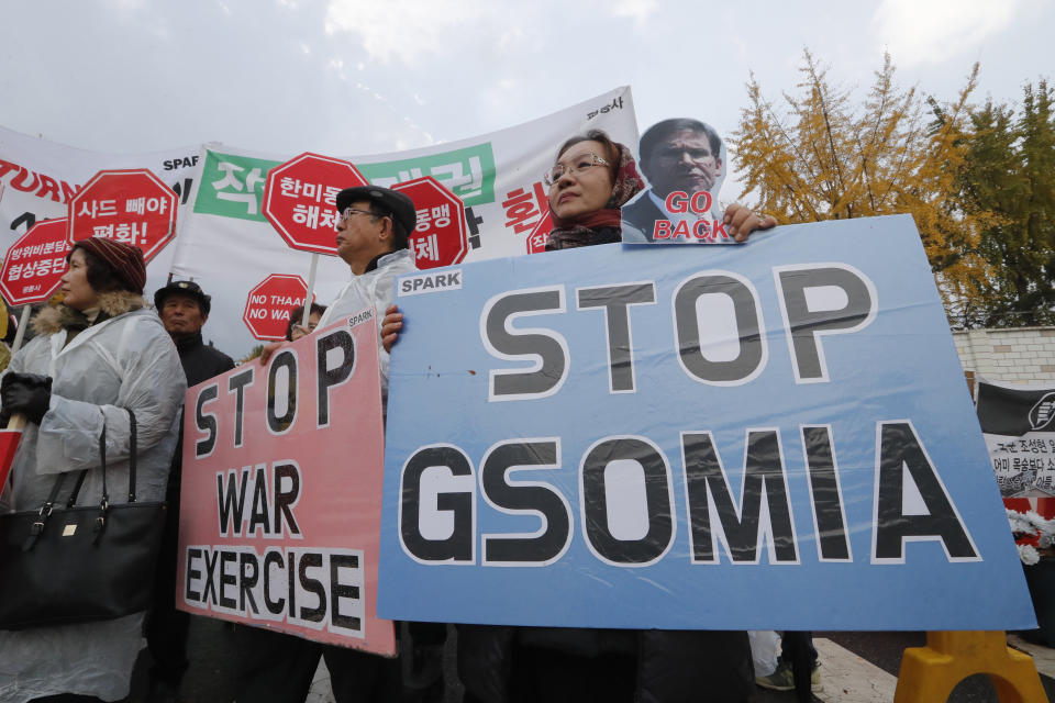 Protesters stage a rally to oppose a visit by U.S. Secretary for Defense Mark Esper in front of the Defense Ministry in Seoul, South Korea, Friday, Nov. 15, 2019. The sign reads "We demand to abolish the General Security of Military Information Agreement, or GSOMIA, an intelligence-sharing agreement between South Korea and Japan." (AP Photo/Ahn Young-joon)