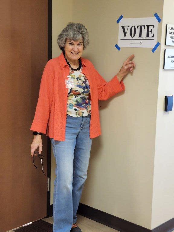 Commissioner Terry Cook points to a sign at the Williamson County Jester Annex polling location in Round Rock where she voted early in the primary election on Feb. 23.