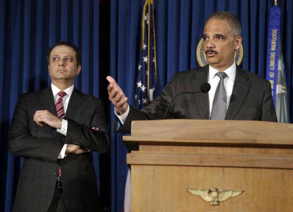 U.S. Attorney General Eric Holder, right, speaks while U.S. Attorney for the Southern District of New York Preet Bharara looks on during a news conference in New York, Tuesday, April 1, 2014. Holder says the successful prosecution of Osama bin Laden's son-in-law in New York shows terror trials can be safely held in the United States.(AP Photo/Seth Wenig)