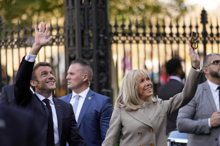 French President Emmanuel Macron and his wife Brigitte Macron waves to the crowd as they arrive at Jackson Square in New Orleans, Friday, Dec. 2, 2022. (AP Photo/Gerald Herbert)