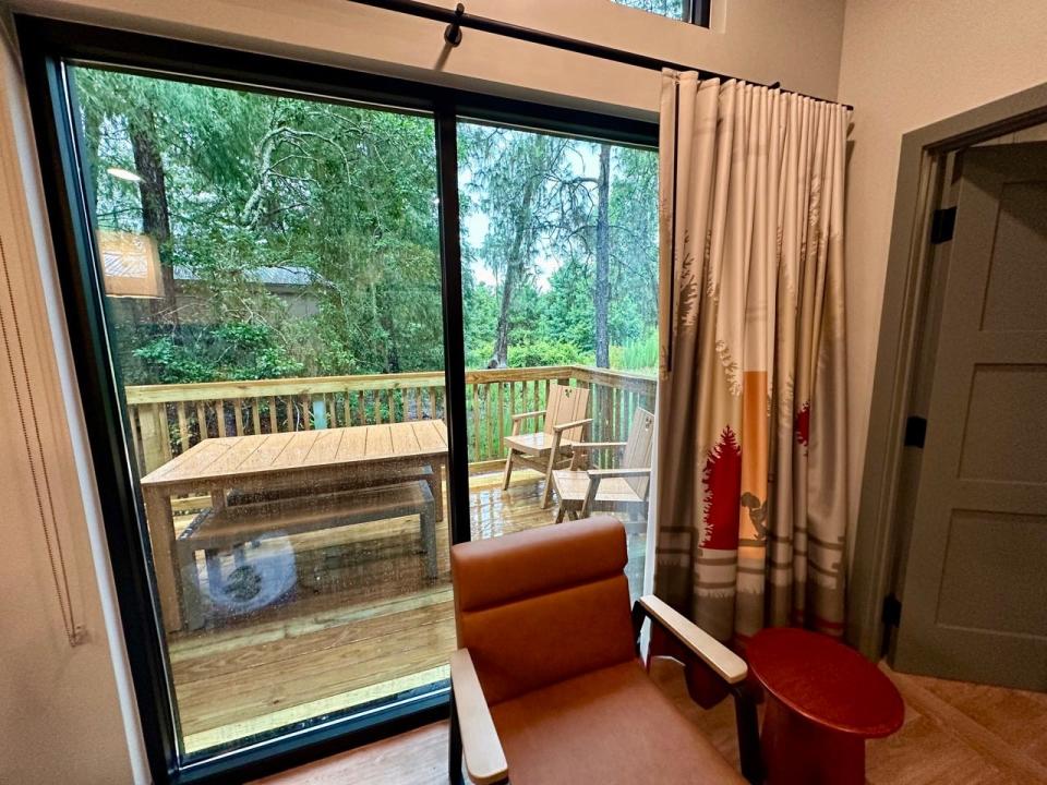 View of balcony through glass doors of Fort Wilderness cabin 