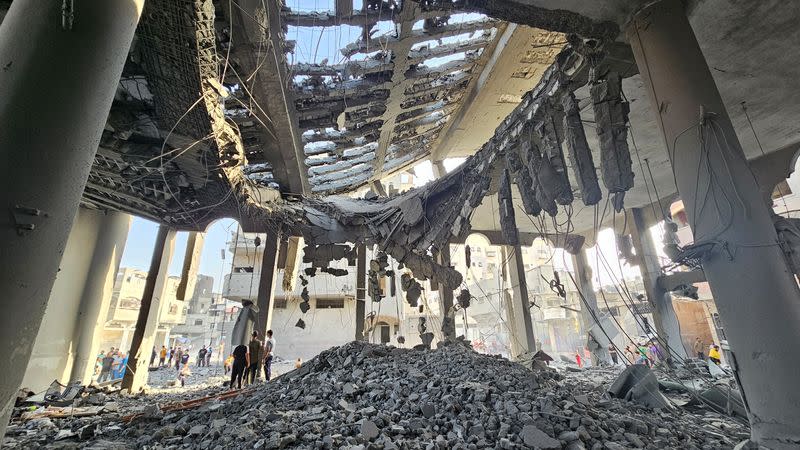 Palestinians inspect the remains of a mosque destroyed in Israeli strikes, in the northern Gaza Strip