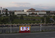 A billboard displaying Chinese President Xi Jinping and Nepalese president Bidhya Devi Bhandari stands in front of the Nepalese parliament in Kathmandu, Nepal, Saturday, Oct. 12, 2019. Xi arrived Saturday from New Delhi, where he met with Indian Prime Minister Narendra Modi. He was received by Nepalese President Bidhya Devi Bhandari and Prime Minister K.P. Sharma Oli at the Kathmandu airport. (AP Photo/Niranjan Shrestha)