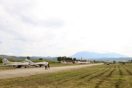 Albanian Air Force members walk near MiG-19 jet fighters in Kucova Air Base in Kucova, Albania, October 3, 2018. REUTERS/Florion Goga