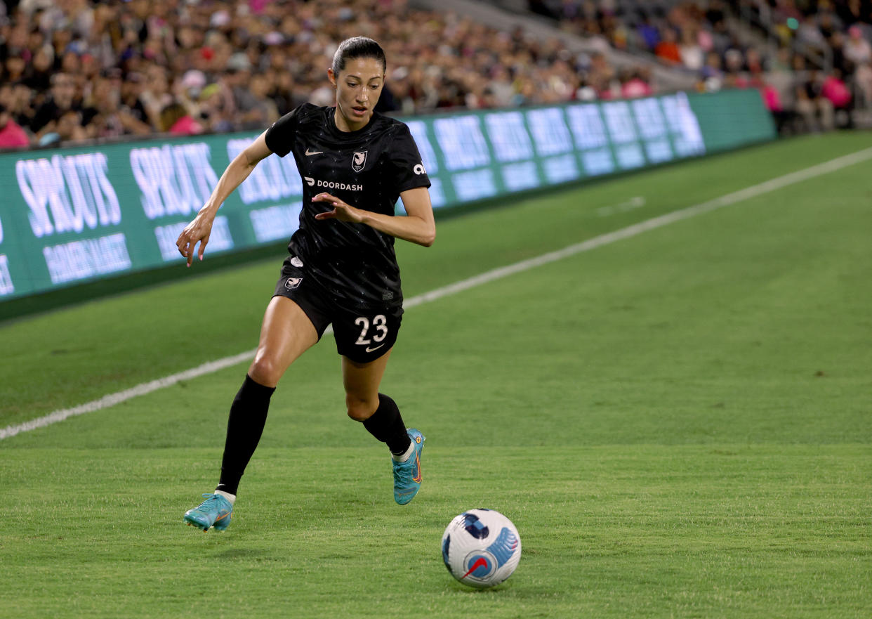 LOS ANGELES, CALIFORNIA - JUNE 07: Christen Press #23 of Angel City FC chases after a ball to the corner during the game against the Houston Dash at Banc of California Stadium on June 07, 2022 in Los Angeles, California. (Photo by Harry How/Getty Images)