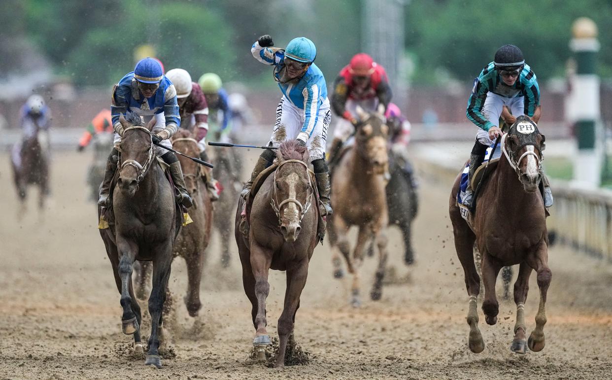 Jockey Javier Castellano raises his fist in celebration after he and Mage won the 149th Kentucky Derby Saturday at Churchill Downs in Louisville, Ky. May, 6, 2023.