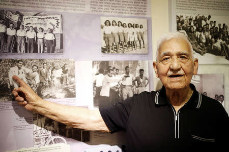 Zevulun Hareli, 90, who immigrated from Iraq to Israel in 1949, points at photos on display at the Babylonian Jewry Heritage Center in Or Yehuda, Israel, April 16, 2018. Picture taken April 16, 2018. REUTERS/Amir Cohen