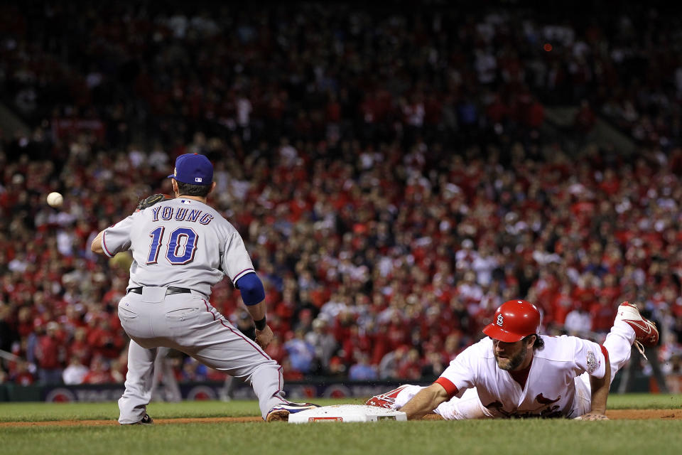 ST LOUIS, MO - OCTOBER 28: Lance Berkman #12 of the St. Louis Cardinals is safe at first base before the play by Michael Young #10 of the Texas Rangers in the seventh inning during Game Seven of the MLB World Series at Busch Stadium on October 28, 2011 in St Louis, Missouri. (Photo by Jamie Squire/Getty Images)