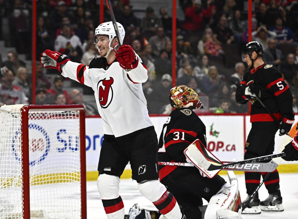 New Jersey Devils right wing Nathan Bastian (14) celebrates his goal as Ottawa Senators goaltender Anton Forsberg (31) looks on during first period of an NHL hockey game in Ottawa, on Saturday, Nov. 19, 2022. (Justin Tang /The Canadian Press via AP)